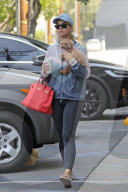Katy Perry cuddles her adorable pet dog, Nugget, as she steps out for a meeting in Santa Monica