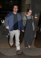 Gary Oldman and his wife Gisele Schmidt are seen holding hands as they arrive at LAX. 