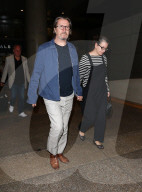 Gary Oldman and his wife Gisele Schmidt are seen holding hands as they arrive at LAX. 