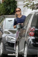 Pippa Middleton peeps around a parked car as she tries to hail a taxi in Central London