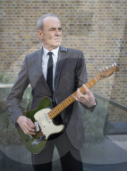 Francis Rossi of Status Quo with his famous green Fender Telecaster guitar .