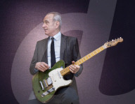 Francis Rossi of Status Quo with his famous green Fender Telecaster guitar .
