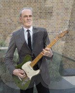 Francis Rossi of Status Quo with his famous green Fender Telecaster guitar .