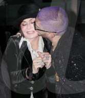 PREMIUM EXCLUSIVE Shasron Osbourne Looks Super Uncomfortable As Family Friend Plants A Kiss On Her Cheek