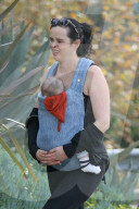 Hollywood actress Krysten Ritter is every inch the protective mommy as she carries her infant son Bruce in a baby harness.