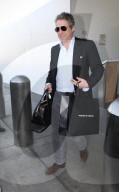 PREMIUM EXCLUSIVE Hugh Grant Lands At LAX After Voicing Support For Prince Harry