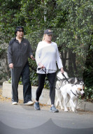 KISS frontman Gene Simmons is seen dressed in a backwards cap, black sweatpants and a matching top as walks his two dogs, George and Baby, with his wife, former Playboy playmate of the year, Shannon Tweed. 