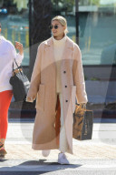 Hailey Baldwin in large beige coat