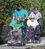 Kirk Douglas, 101, and Anne Buydens, 99, seen on an outing with their caretakers. 