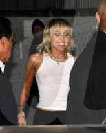 EXCLUSIVE: Miley Cyrus leaves Chateau Marmont wearing a plain white tank top