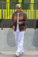 Rapper Rick Hilfiger appears to smoke a suspicious cigarette as he relaxes on the streets of LA despite the coronavirus shutdown