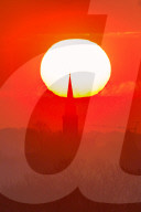 FEATURE - Ein Vogel sitzt bei Sonnenaufgang in Leeds auf einem Wetterhahn in Leeds
