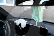 NEWS - Coronavirus: Symbolbild einer Schutzmaske und Handschuh im Auto