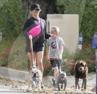Reese Witherspoon showing her legs walking her three dogs 