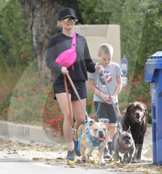 Reese Witherspoon showing her legs walking her three dogs 