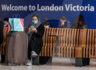Train travellers at Victoria Station wear protective masks