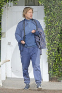 Owen Wilson and a glamorous female companion load up his car with belongings as they appear to be moving between his houses in Los Angeles