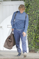 Owen Wilson and a glamorous female companion load up his car with belongings as they appear to be moving between his houses in Los Angeles