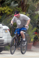 Adam Sandler enjoys a leisurely bike ride around his Malibu neighborhood as he takes a break during lockdown