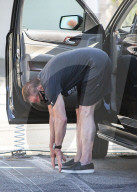 Arnold Schwarzenegger Stretching After a Bicycle Ride With son Joseph Baena