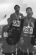 American sprinters who broke the existing world and Olympic records in the men's 400 metres event at the 1968 Olympic Games on the victory podium after medal awarding ceremonies . Left to right , Ronald Freeman third , gold medallist Lee Evans , and silve