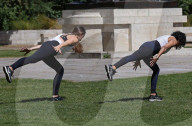 Women exercise in a central London park as they enjoy the warm weather.