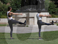 Women exercise in a central London park as they enjoy the warm weather.