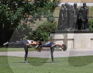 Women exercise in a central London park as they enjoy the warm weather.