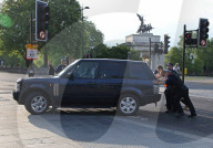 Armed Police stop to assist a motorist after his Range Rover broke down, they pushed it out of the Road at Hyde Park Corner.