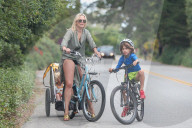 Bikini-clad Molly Sims has her hands full as she takes her three kids for a bike ride near her beach home in Santa Barbara. 