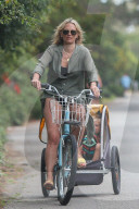 Bikini-clad Molly Sims has her hands full as she takes her three kids for a bike ride near her beach home in Santa Barbara. 