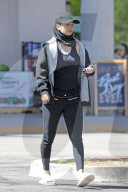 Kaley Cuoco cuts an athletic figure as exits a grocery store with husband of almost two years, wealthy equestrian pro Karl Cook. 