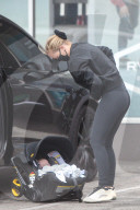 Australian model Lara Bingle steps out the day after her 33rd birthday to go surfboard shopping with her two of her three young children. 