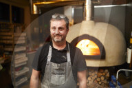 Baker Andrew Twentyman at his pizza restaurant and bakery in Leigh, Greater Manchester.