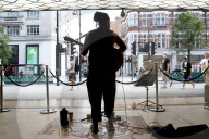 'There's money to be made': buskers return to Britain's high streets 