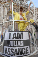 Vivienne Westwood suspended in a giant birdcage 