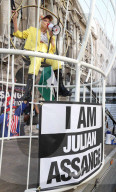Vivienne Westwood suspended in a giant birdcage 
