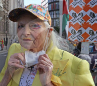Vivienne Westwood suspended in a giant birdcage 