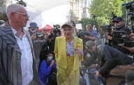 Vivienne Westwood suspended in a giant birdcage 