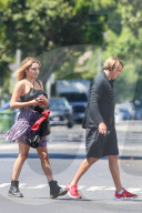 Sean Stewart lets his actress girlfriend Helen OÍGara carry his boxing gloves as he limps away from an hour-long boxing class at a private gym in Los Angeles.