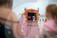 'Telly just isn't the same': glorious return of English seaside entertainment. People young and old enjoy silly fun of Uncle Tacko’s flea circus and a Punch and Judy show in Devon