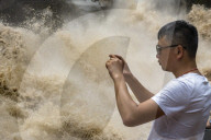 Tourists visit Tiger Leaping Gorge during high water