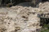 Tourists visit Tiger Leaping Gorge during high water