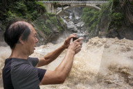 Tourists visit Tiger Leaping Gorge during high water