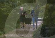 Boris Johnson running with his trainer this morning in Westminster. 