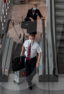 Travellers wear masks at London Heathrow as new rules making face masks mandatory comes into force in England 