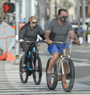 Arnold Schwarzenegger, 73 and his long term girlfriend of 5 years, Heather Milligan, 45 are spotted taking their bikes for an early morning ride in Santa Monica, CA