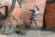 Banksy confirms hula-hoop girl mural in Nottingham is his
Artwork showing girl playing with a bicycle tyre appeared on street corner last week