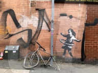 Banksy confirms hula-hoop girl mural in Nottingham is his
Artwork showing girl playing with a bicycle tyre appeared on street corner last week