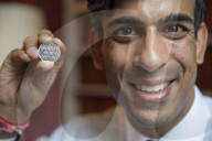 Rishi Sunak UK Chancellor with the new 50p piece .
